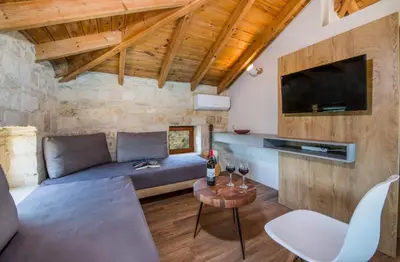 a living room with a couch and a table at Villa Kourouni in Stalos