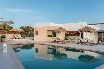 a villa with a swimming pool and a house at Alianthos Villa in Tersanas