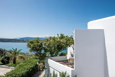 a white house with a view of the ocean at Alianthos Villa in Tersanas