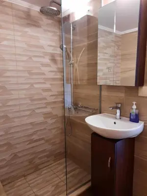 a bathroom with a sink and a shower at Stone Mansion in Káïna