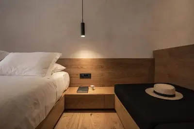 a bedroom with a bed with a hat on a table at Monastery Estate Venetian Harbor in Chania Town