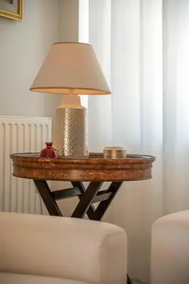 a table with a lamp on it next to a couch at Nikola's Villa Stalos Chania in Stalos