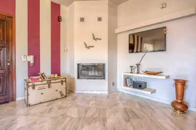a living room with a fireplace and a mirror at Nikola's Villa Stalos Chania in Stalos