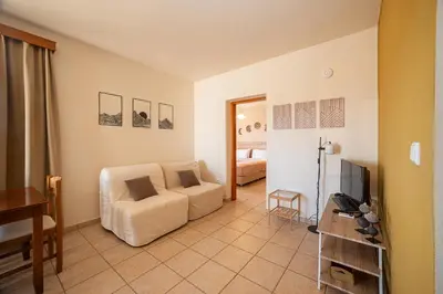 a living room with a couch and a television at Mini Art Apartments in Gerani Chanion