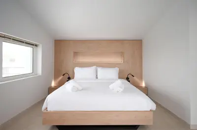 a bedroom with a white bed with two towels on it at Villa Giota in Chania Town