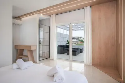 a bedroom with a bed with white towels on it at Villa Giota in Chania Town