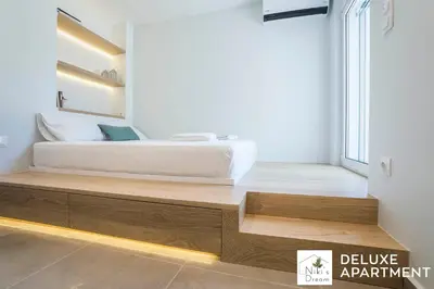 a bedroom with a bed on a wooden platform at Nikis Dream Comfy Apartments in Chania Town