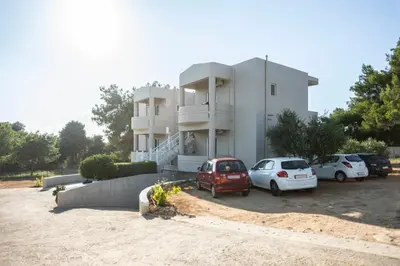 a white building with cars parked in front of it at Nikis Dream Comfy Apartments in Chania Town