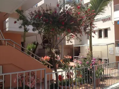 a building with a bunch of flowers in a courtyard at Kallitsakis Beach in Plataniás