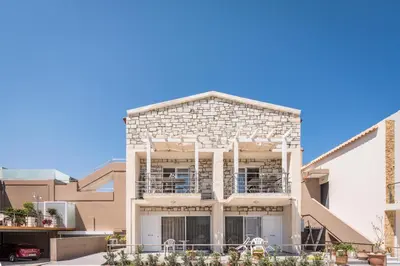 a white brick building with a balcony at Athina Apartments Near The Sea Platania in Plataniás