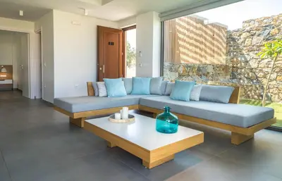 a living room with a couch and a table at Iskios Villas in Agia Marina Nea Kydonias