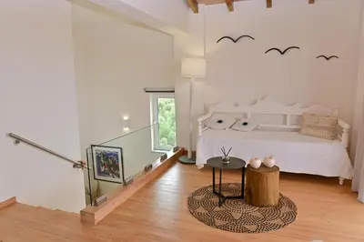 a bedroom with a bed with bats on the wall at Elia Seaside Villa, Amazing 2-Story Eco Pool House! in Kissamos