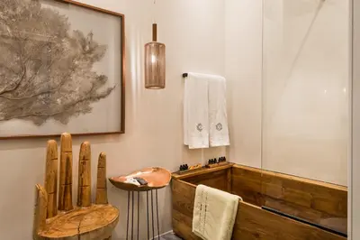 a bathroom with a wooden tub and a wooden chair at Nyx Chic Manor in Chania Town