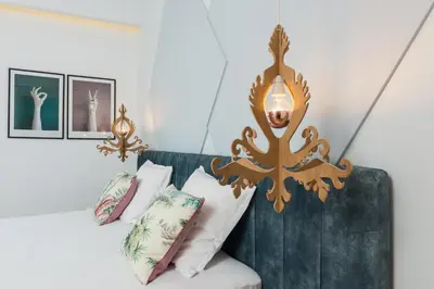 a room with a couch with pillows and a lamp at Nyx Chic Manor in Chania Town