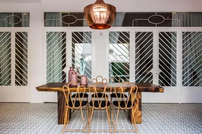 a dining room table with chairs and a light fixture at Nyx Chic Manor in Chania Town