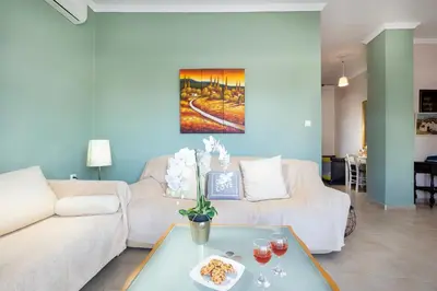 a living room with a couch and a table at Irini Apartment II in Kalyves