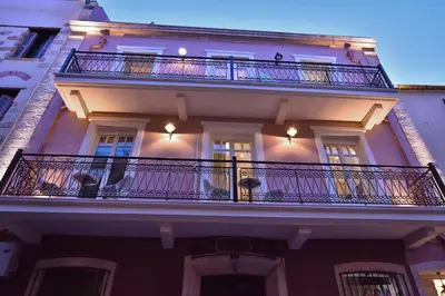 a large white building with a balcony at Consolato Boutique in Chania Town