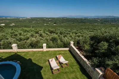an aerial view of a yard with two chairs and a pool at Villa Stellina in Marathokefála