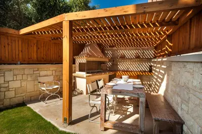 a patio with a wooden pergola and a table at Villa Stellina in Marathokefála