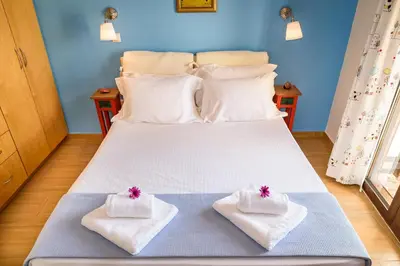 a bed with two towels on top of it at Platanias Sky View in Plataniás