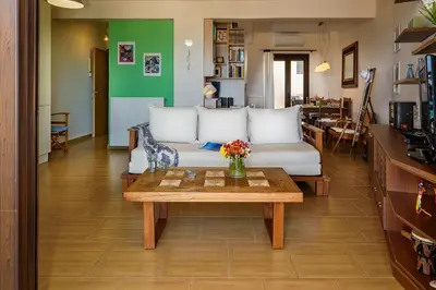 a living room with a couch and a table at Platanias Sky View in Plataniás