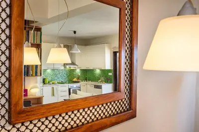 a mirror hanging on a wall next to a kitchen at Platanias Sky View in Plataniás