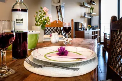 a table with a plate and a bottle of wine at Platanias Sky View in Plataniás