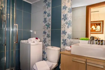 a bathroom with a toilet and a sink and a mirror at Platanias Sky View in Plataniás