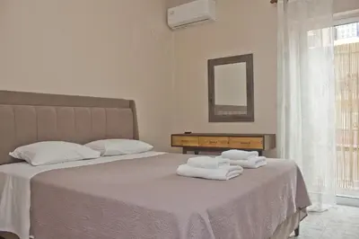 a bedroom with two white towels on a bed at Danaos Hotel in Chania Town