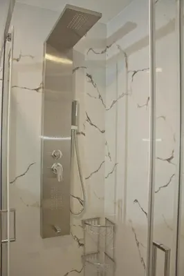 a shower with a glass door in a bathroom at Danaos Hotel in Chania Town