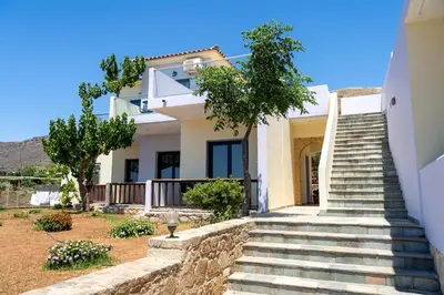 a white house with stairs in front of it at Adam in Falasarna