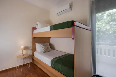 two bunk beds in a small room with a window at Vaggelio House in Chania Town