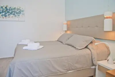 a bedroom with a bed with two towels on it at Christina Beach Hotel in Chania Town