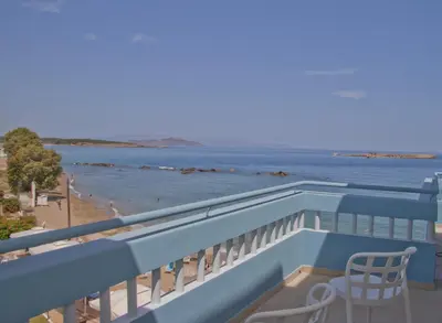 a balcony with a chair and a view of the beach at Christina Beach Hotel in Chania Town