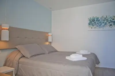 a bedroom with a bed with towels on it at Christina Beach Hotel in Chania Town