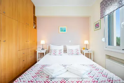 a bedroom with a bed with two pillows on it at Vrahokipos Villa in Kounoupidhianá