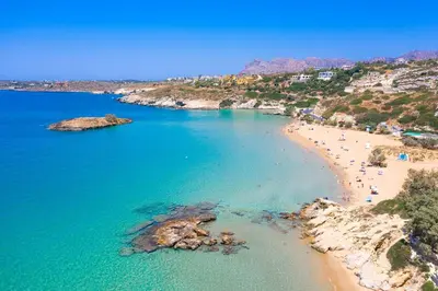 an aerial view of a beach with people in the water at Vrahokipos Villa in Kounoupidhianá