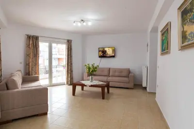 a living room with a couch and a table at Chania Sea View Apartment with Free Private Parking in Chania Town