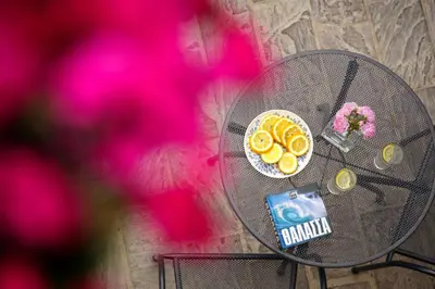 a glass table with a cake and flowers on it at La Casa Piccola in Chania Town