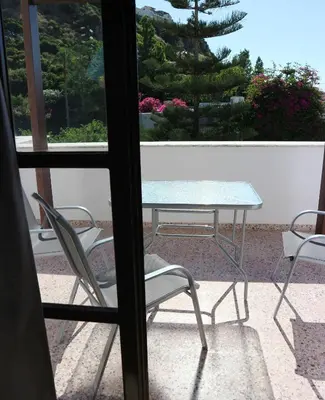 a table and chairs sitting on a patio at Oliaria Apartments in Plataniás
