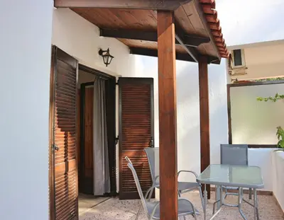 a patio with a table and chairs on a patio at Oliaria Apartments in Plataniás