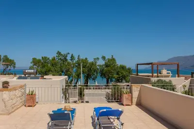 a patio with chairs and a view of the ocean at Villa Nopigia Somina in Kissamos