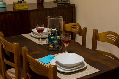 a wooden table with plates and glasses of wine at Lithari in Kámboi