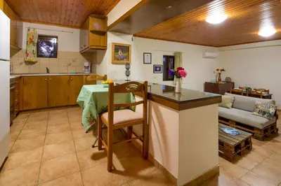 a kitchen and living room with a table and a couch at Lithari in Kámboi