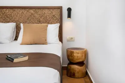 a bedroom with a bed with a book on a table at Villa Tramonto - Falasarna in Falasarna