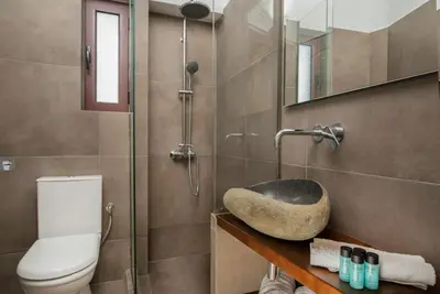 a bathroom with a toilet and a sink and a shower at Villa Tramonto - Falasarna in Falasarna