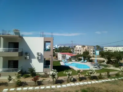 a villa with a swimming pool and a house at Efrilias Studios & Apartments in Kissamos