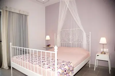a bedroom with a white bed with a canopy at Efrilias Studios & Apartments in Kissamos