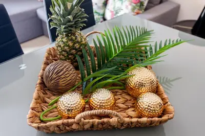 a basket of pineapples on a table with a pineapple at Mary Suites Chania in Chania Town