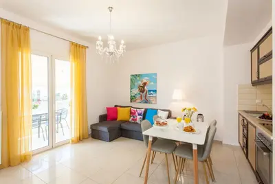 a living room with a couch and a table at Mary Suites Chania in Chania Town